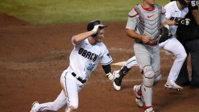 Pavin Smith (26) celebrates after scoring the winning run in the bottom of the 9th inning against the Philadelphia Phillies at Chase Field.